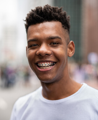 teen boy with braces smiling