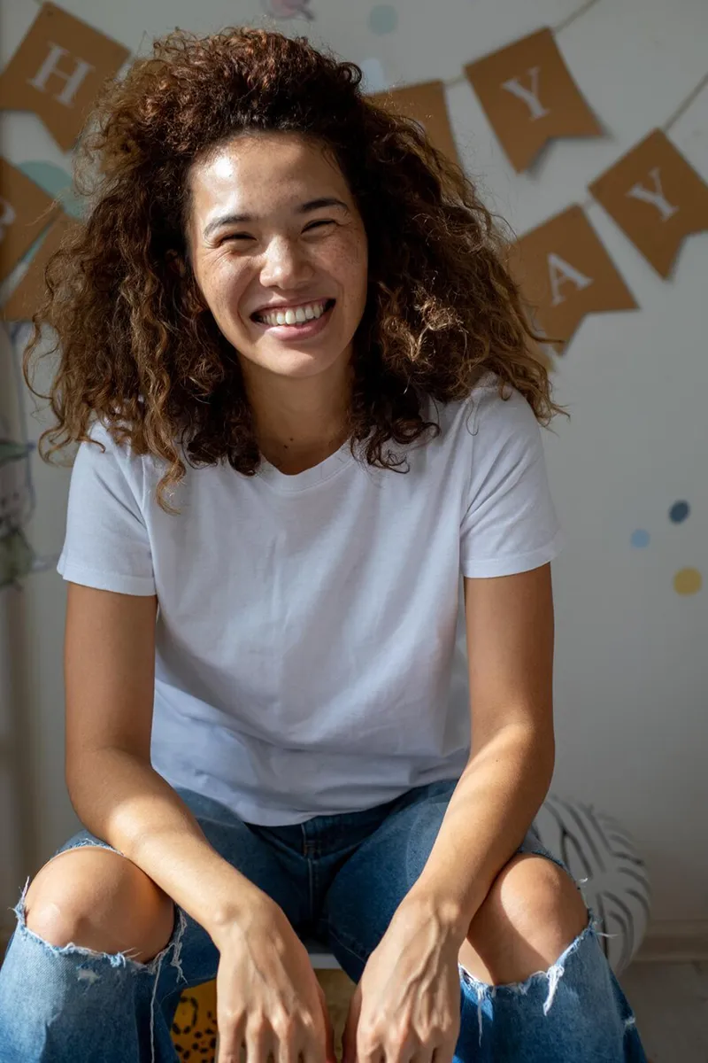 beautiful curly haired mestiza girl smiling at birthday celebration
